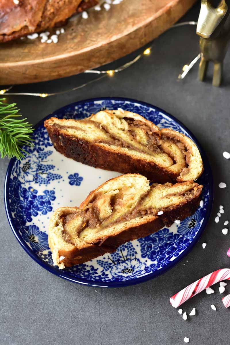 two slices of nut roll with chocolate (babka wreath) on a blue plate