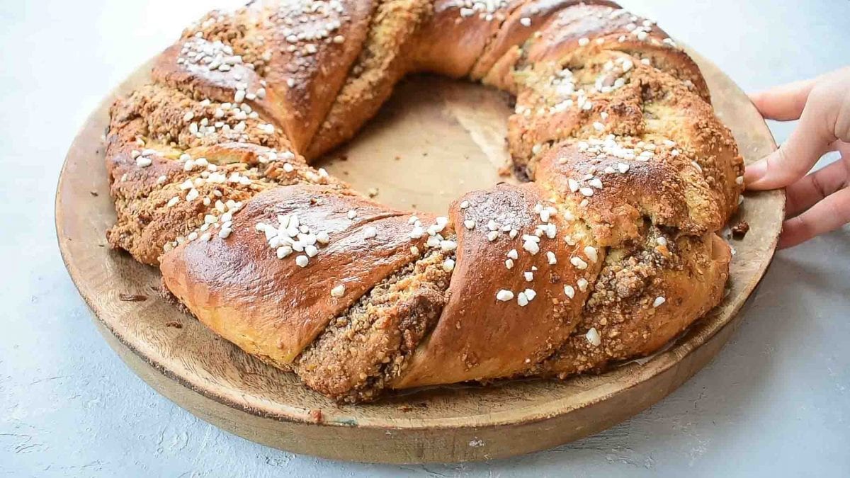 Nut roll with chocolate (babka wreath) on a wooden plate