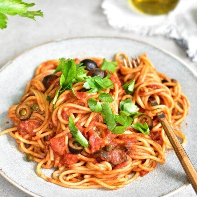 Spaghetti alla puttanesca - tomatoes, olives, capers and anchovies pasta