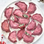 pink pierogi with spinach and potato filling