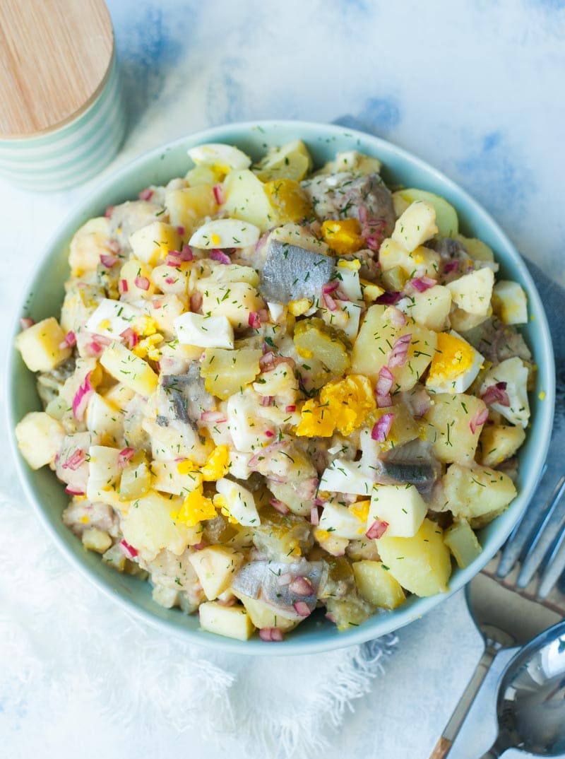 Herring salad with potatoes, eggs, cucumbers in brine and apples.