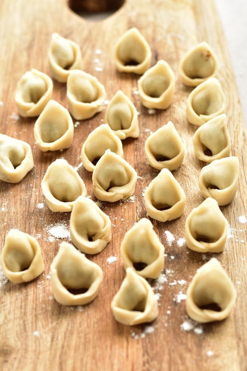 Polish uszka dumplings on a wooden board.