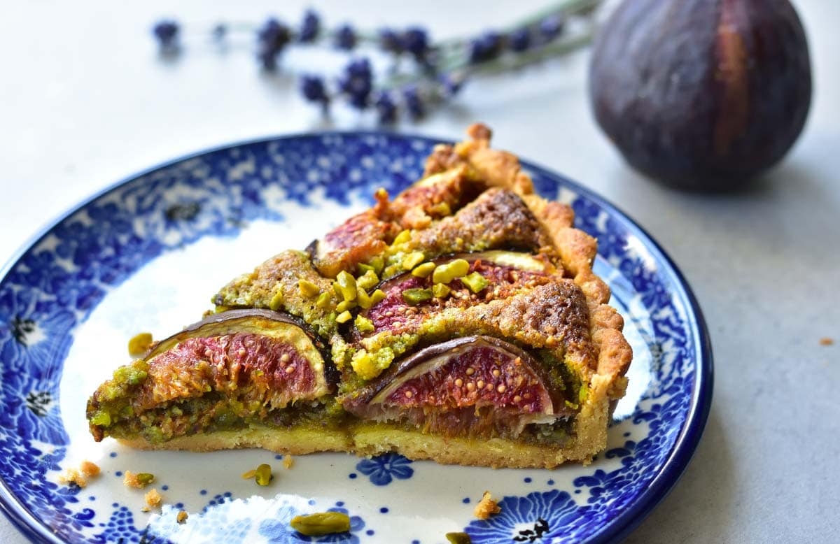 a piece of fig frangipane tart on a blue plate