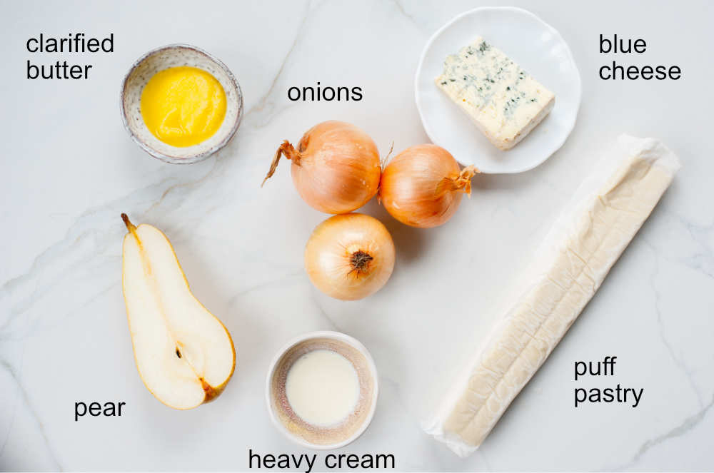 Ingredients needed to prepare puff pastry onion tart with pear and blue cheese.