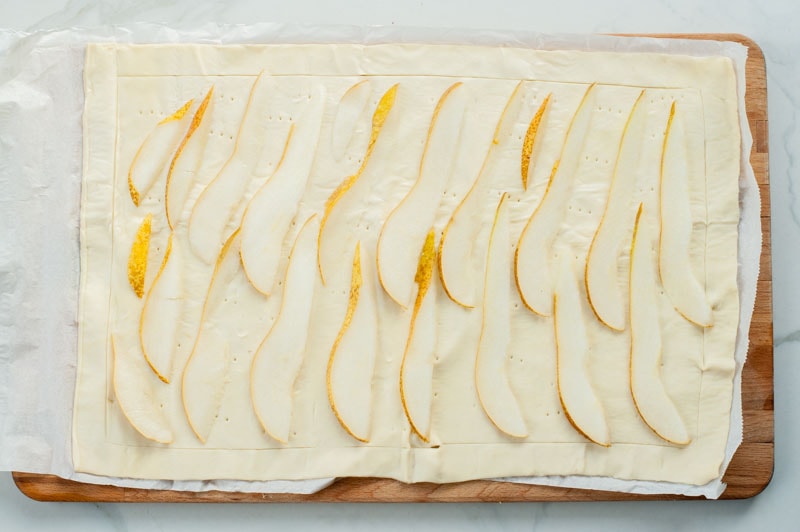 pear slices on a sheet of puff pastry