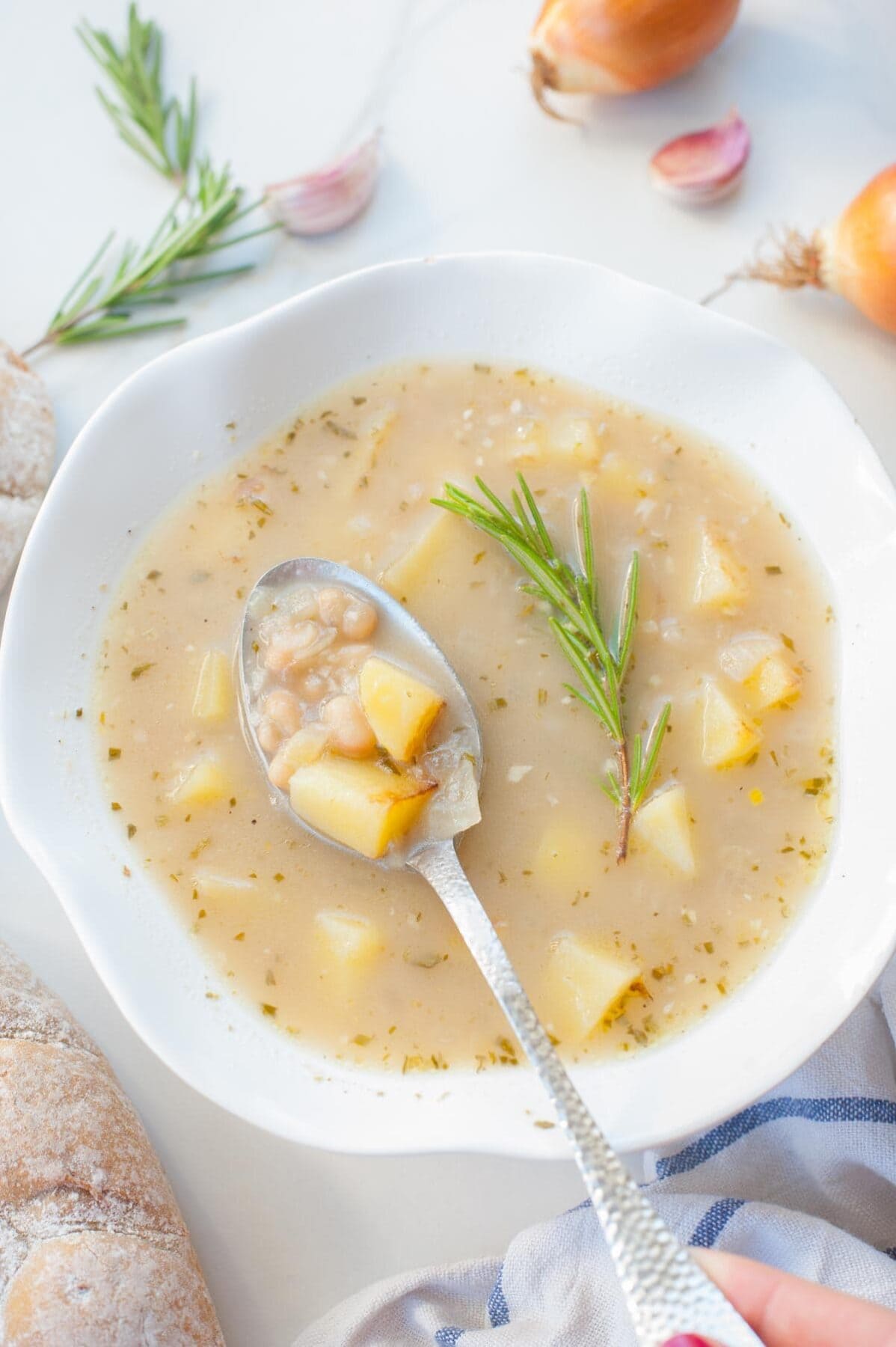Easy cannellini bean soup with garlic and rosemary in a white plate