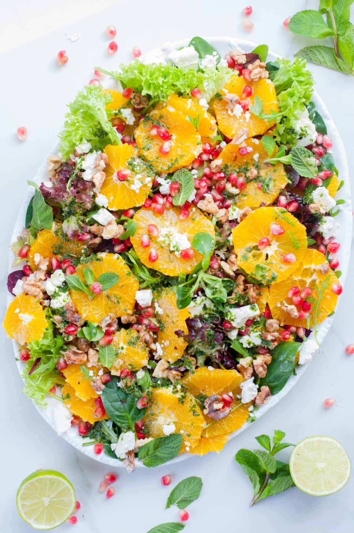 orange pomegranate salad on a white plate