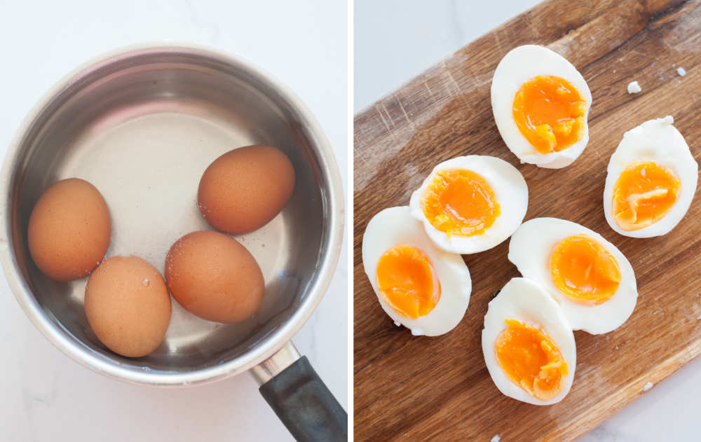 Aggs in a pot, cooked eggs cut in half on a chopping board.