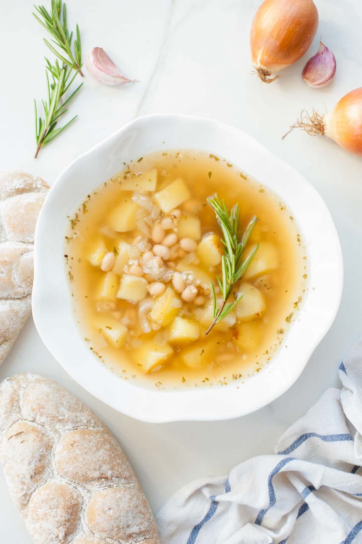 Easy cannellini bean soup with garlic and rosemary in a white plate