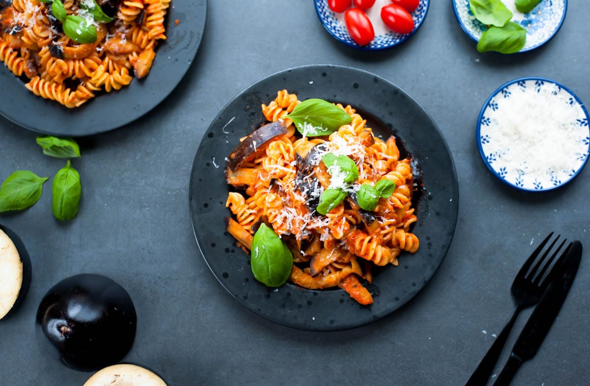 two plates with pasta alla norma (tomato and eggplant pasta)