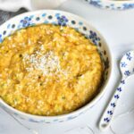 banana oatemal with passion fruit in a white bowl