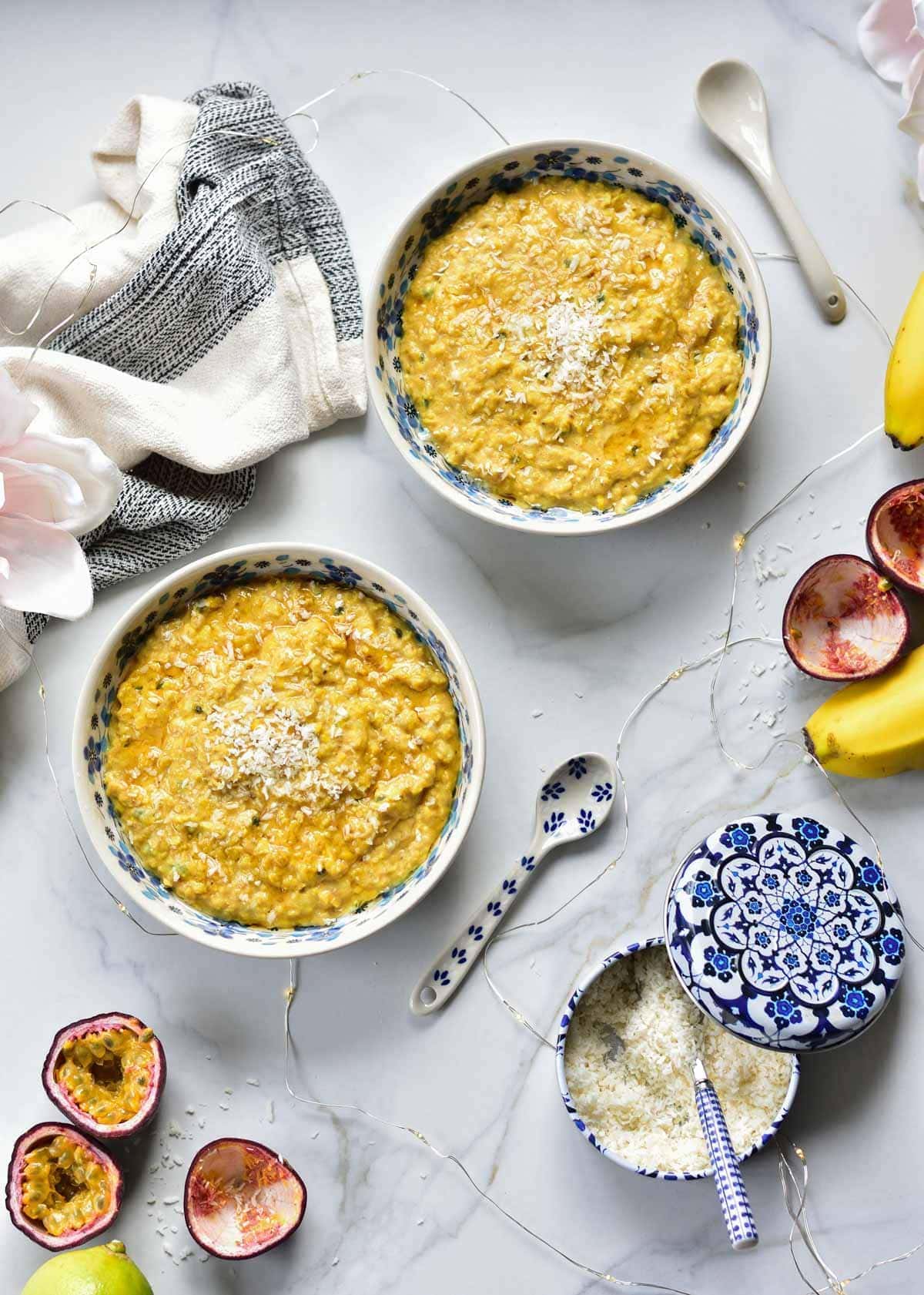 Two bowls with banana oatmeal with passion fruit.