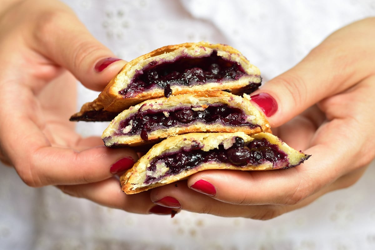 blueberry hand pies held in hands