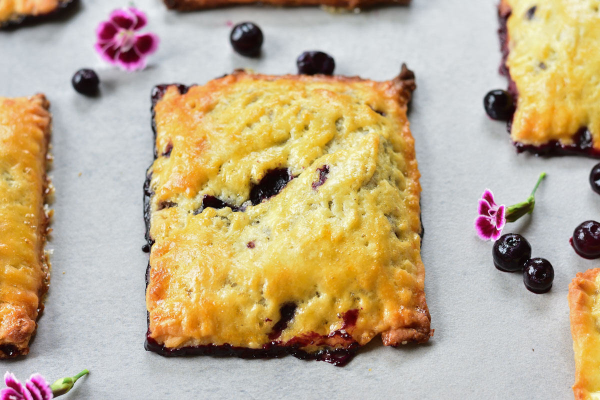 blueberry hand pies on a grey background