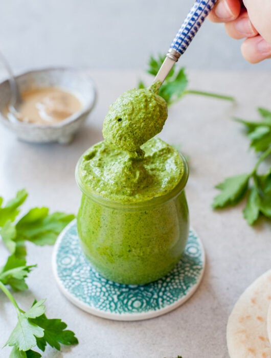 green tahini sauce in a jar