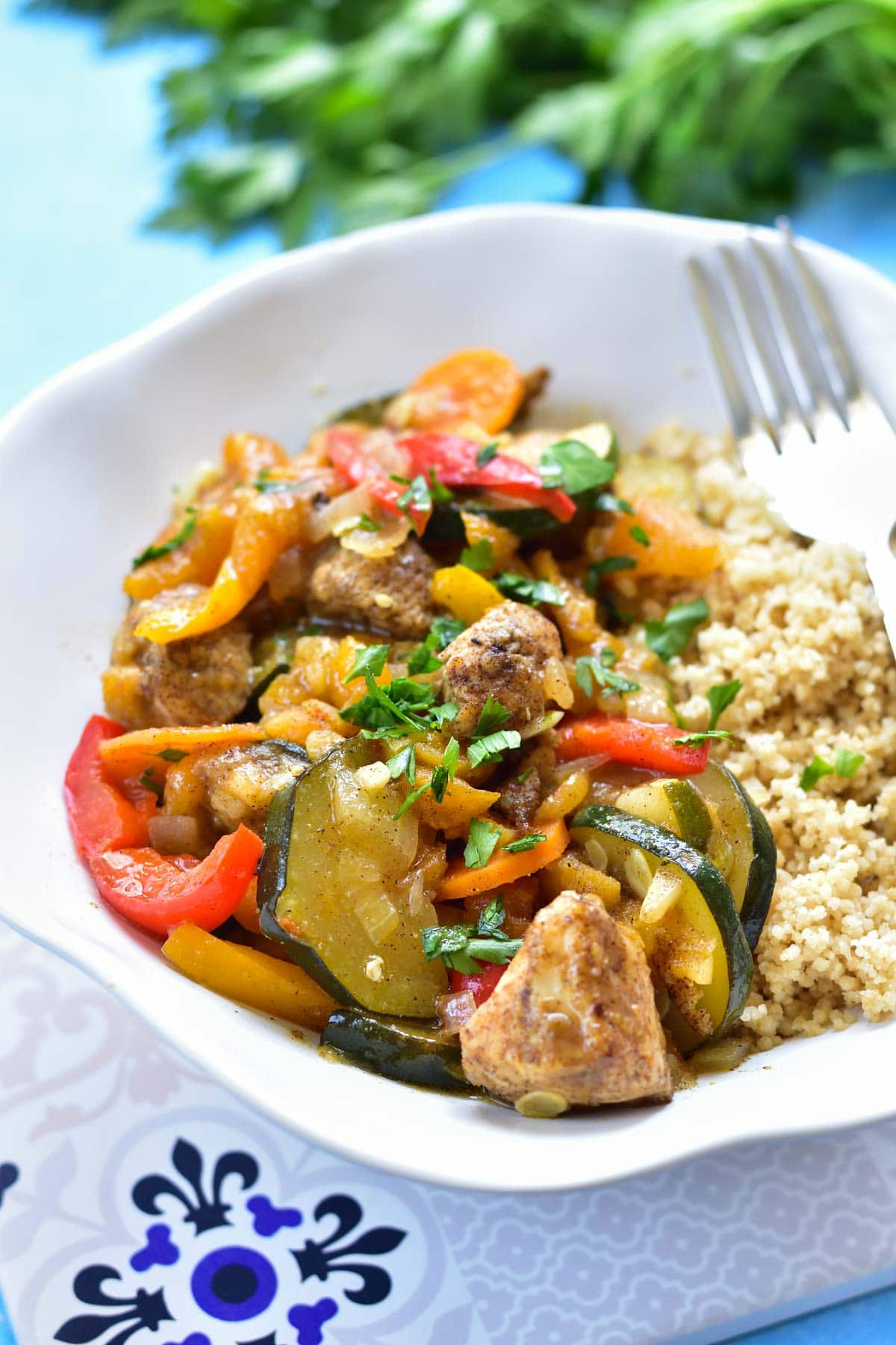 moroccan chicken with apricots and vegetables in a whitle bowl