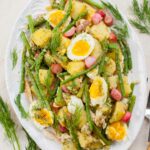 potato and asparagus salad on a white plate