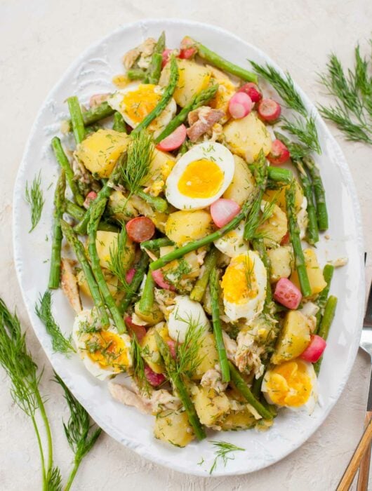 potato and asparagus salad on a white plate