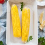 corn on the cob in a white baking dish
