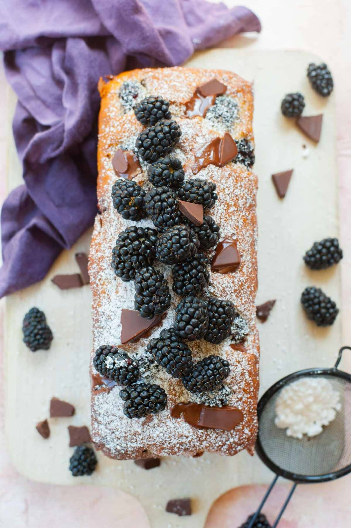 blackberry banana bread with chocolate on a wooden board