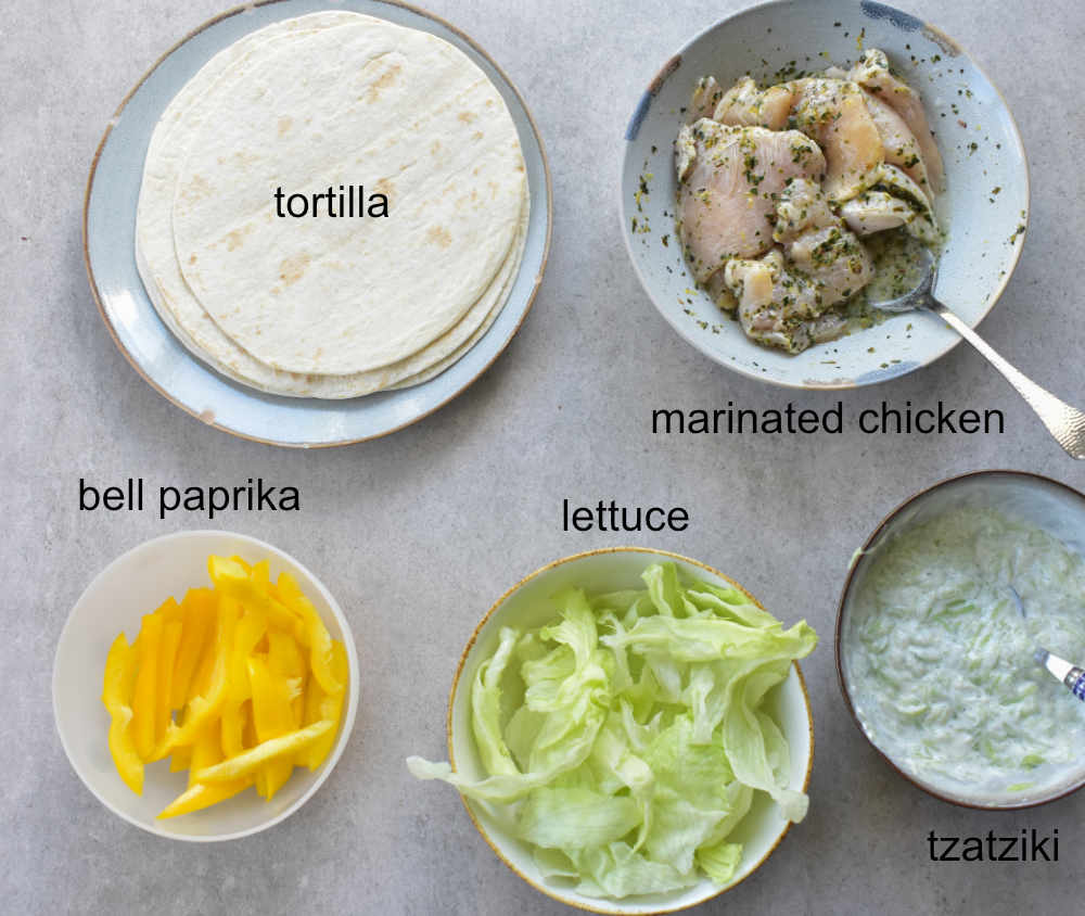 Labeled ingredients for Greek chicken wraps.