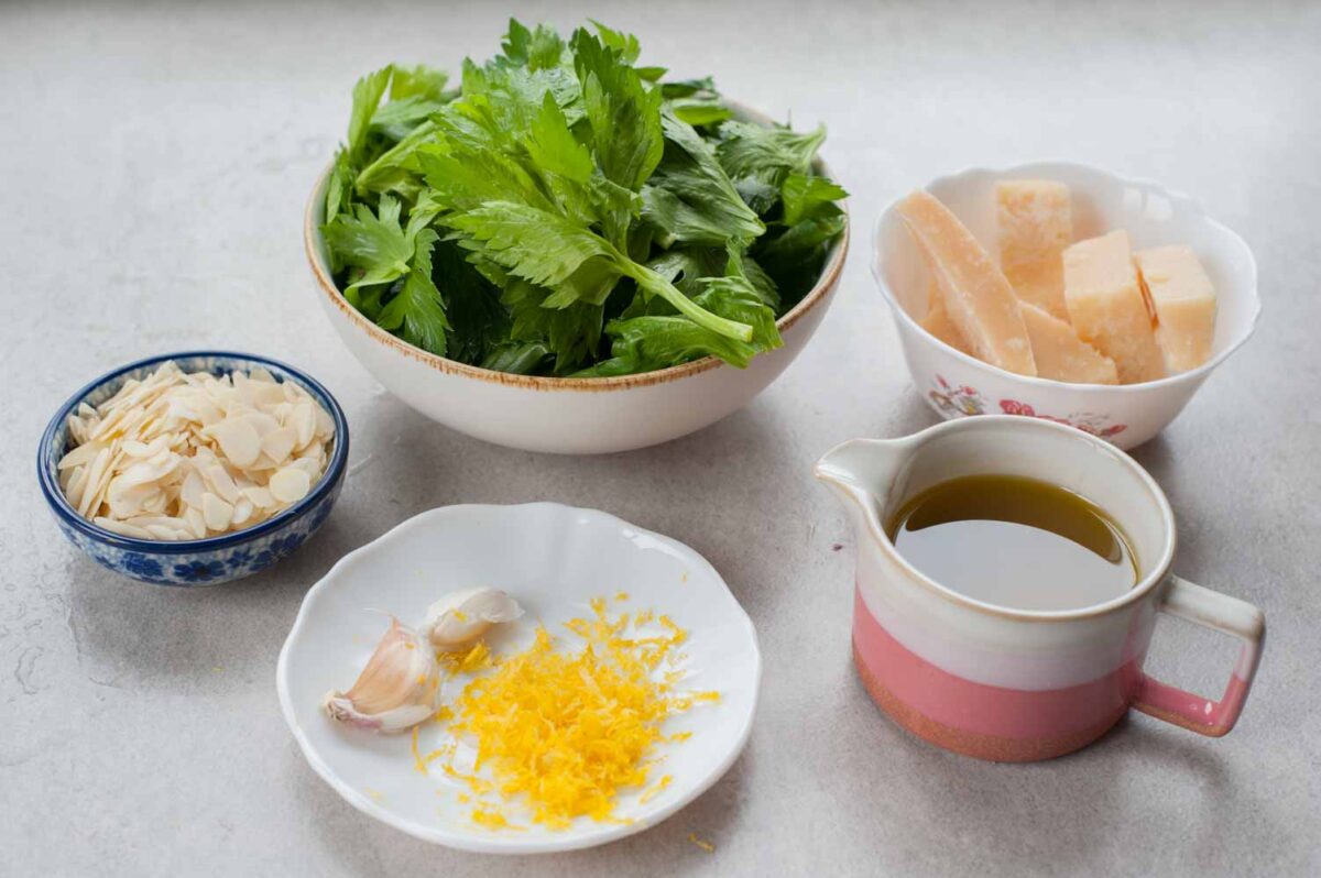 Ingredients needed to prepare celery leaf pesto.