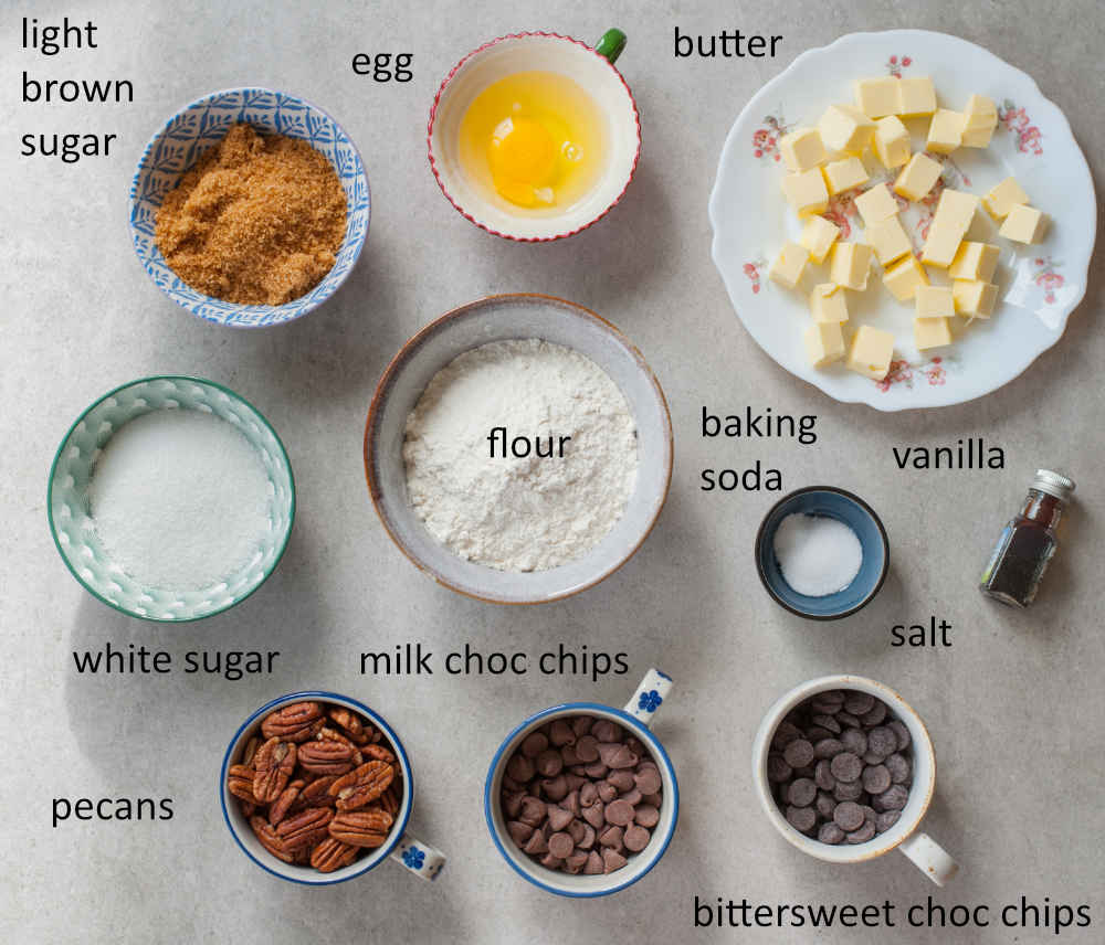 Ingredients needed to prepare chocolate chip pecan cookies.