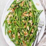 green beans almondine in a large white plate