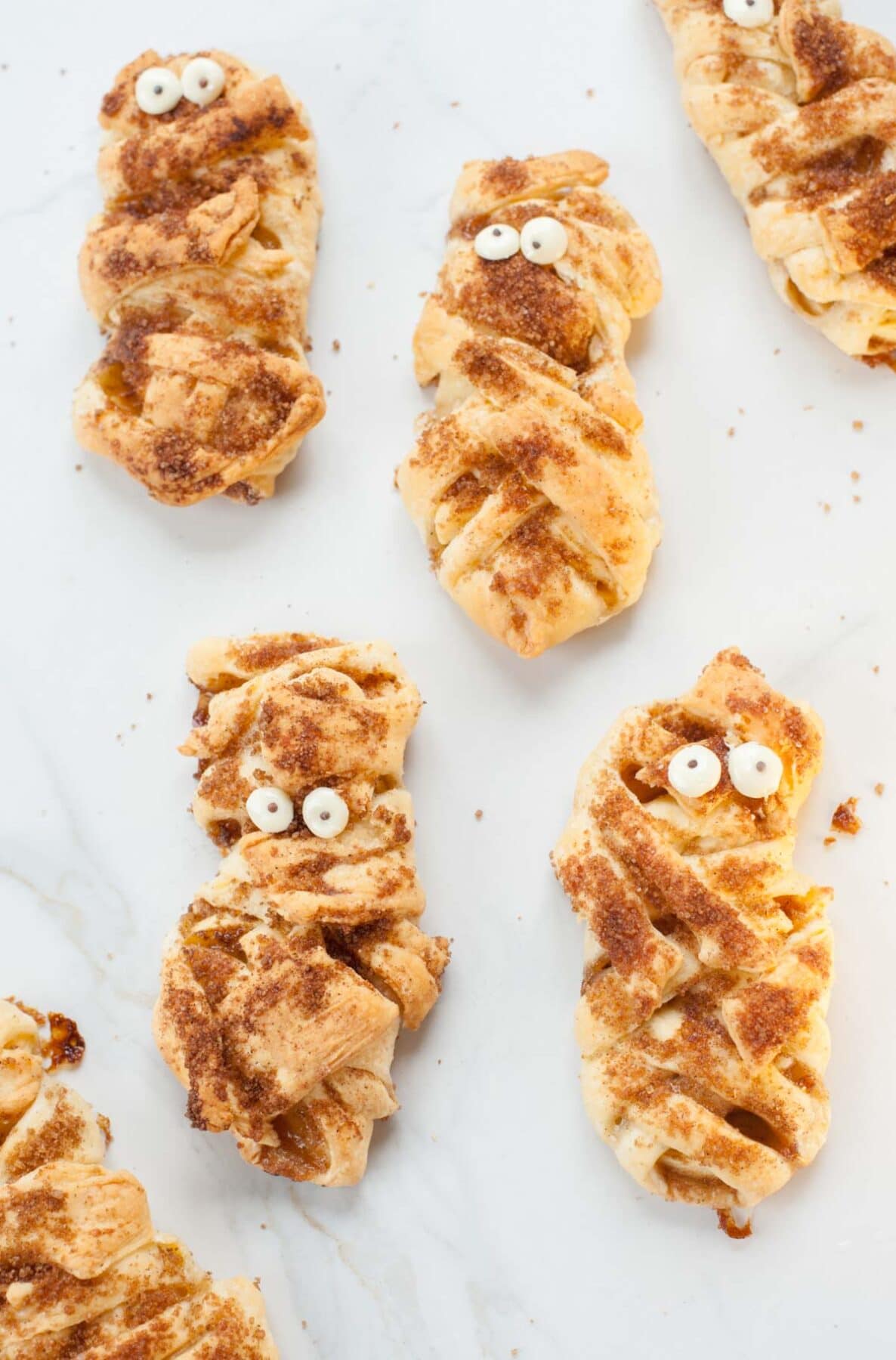 Mummy apple hand pies on a white background.