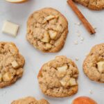 Apple cinnamon oatmeal cookies on a white background. Apples, cinnamon stick, oats on the side.