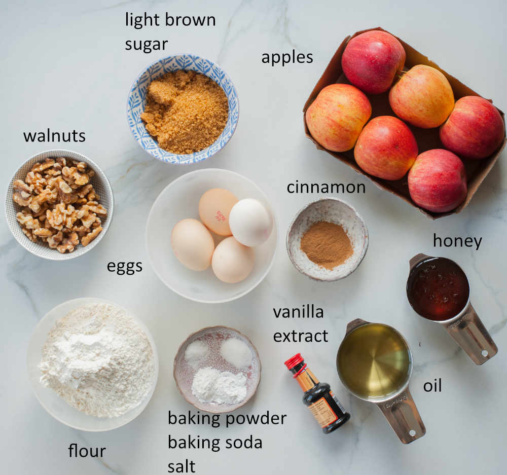 Labeled ingredients needed to prepare apple walnut cake with honey.