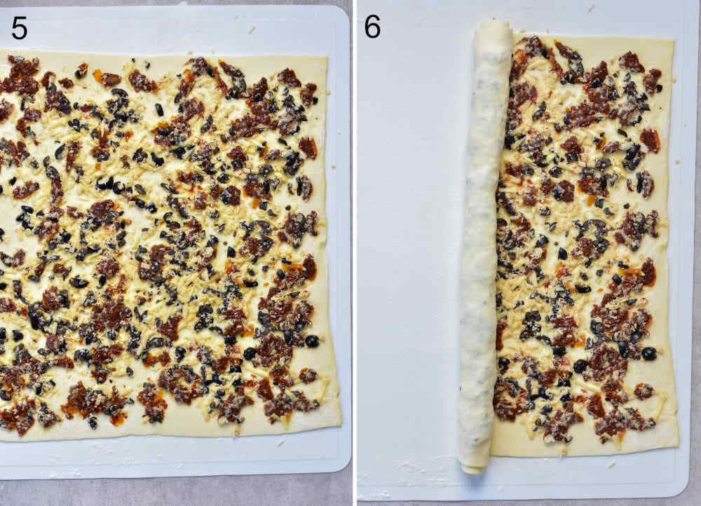 Sun-dried tomato, cheese, and olive filling spread on a puff pastry sheet. Puff pastry sheet is being rolled up.