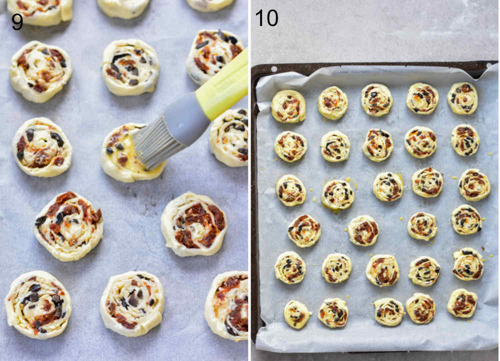 Puff pastry pinwheels are being brushed with egg wash. Puff pastry pinwheels on a parchement paper-lined baking sheet.