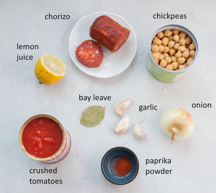Labeled ingredients needed to prepare chickpeas with chorizo in tomato sauce.