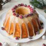 Cranberry orange bundt cake with white chocolate orange glaze and sugared cranberries.