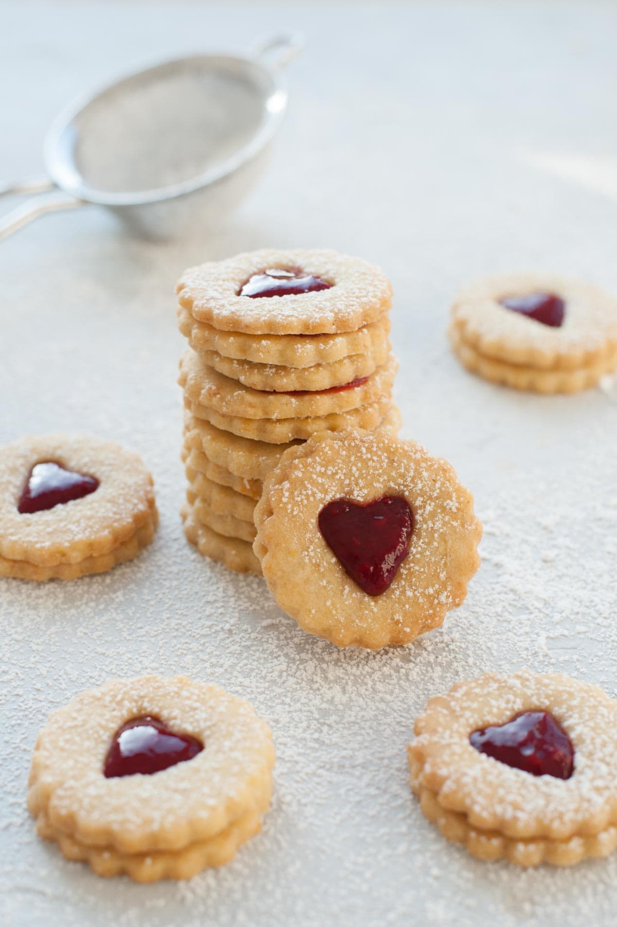 A stack of heart-shaped Linzer cookies.
