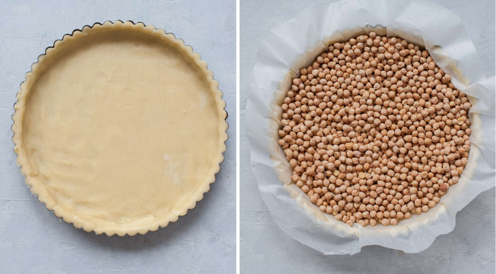 Tart pan with pastry crust. Baking paper with dried chickpeas on top of a pastry crust.