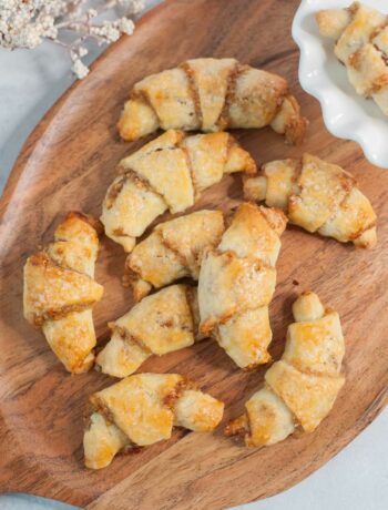 Rogaliki cookies on a chopping board.