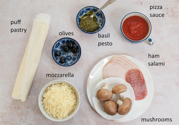 Labeled ingredients needed for puff pastry pizza bites.