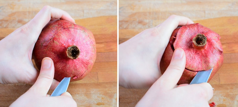 Top of the pomegranate is being cut off with a pairing knife.