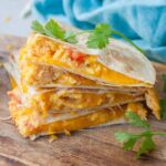 Breakfast quesadilla on a wooden board.