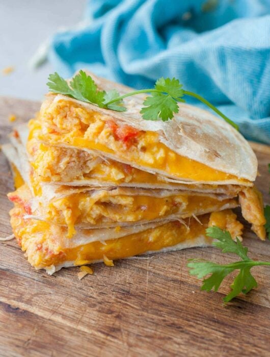 Breakfast quesadilla on a wooden board.