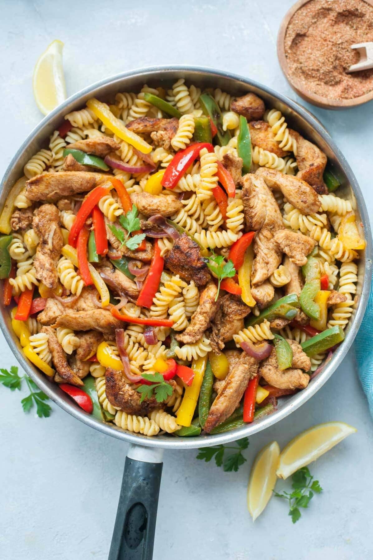 Chicken fajita pasta in a frying pan.