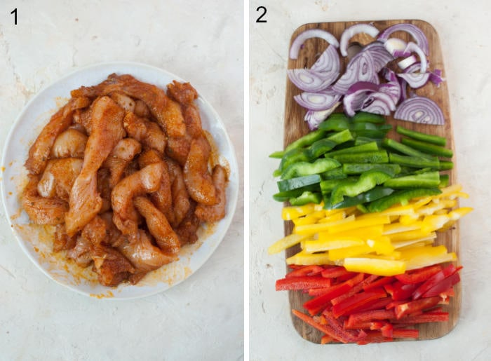 Chicken strips with spices in a bowl. Chopped bell peppers and onion on a chopping board.