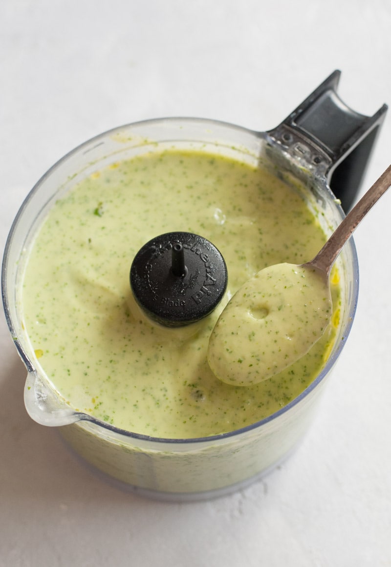 Avocado cilantro lime dressing in a food processor.