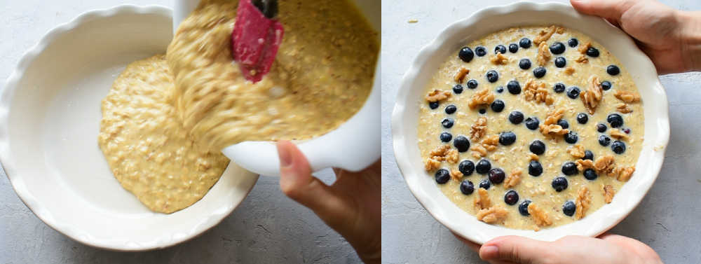 Oatmeal mixture being poured into a white baking dish. Mixture is topped with blueberries and walnuts.