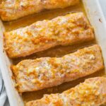 Orange maple salmon in a white baking dish.