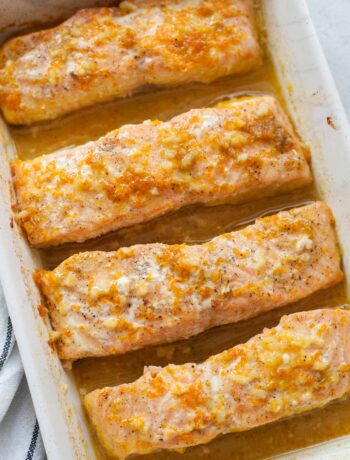 Orange maple salmon in a white baking dish.