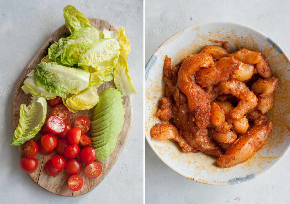 Vegetables on a wooden board. Chicken strips tossed with spices in a bowl.