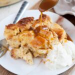 Brioche bread pudding is being drizzled with caramel sauce.